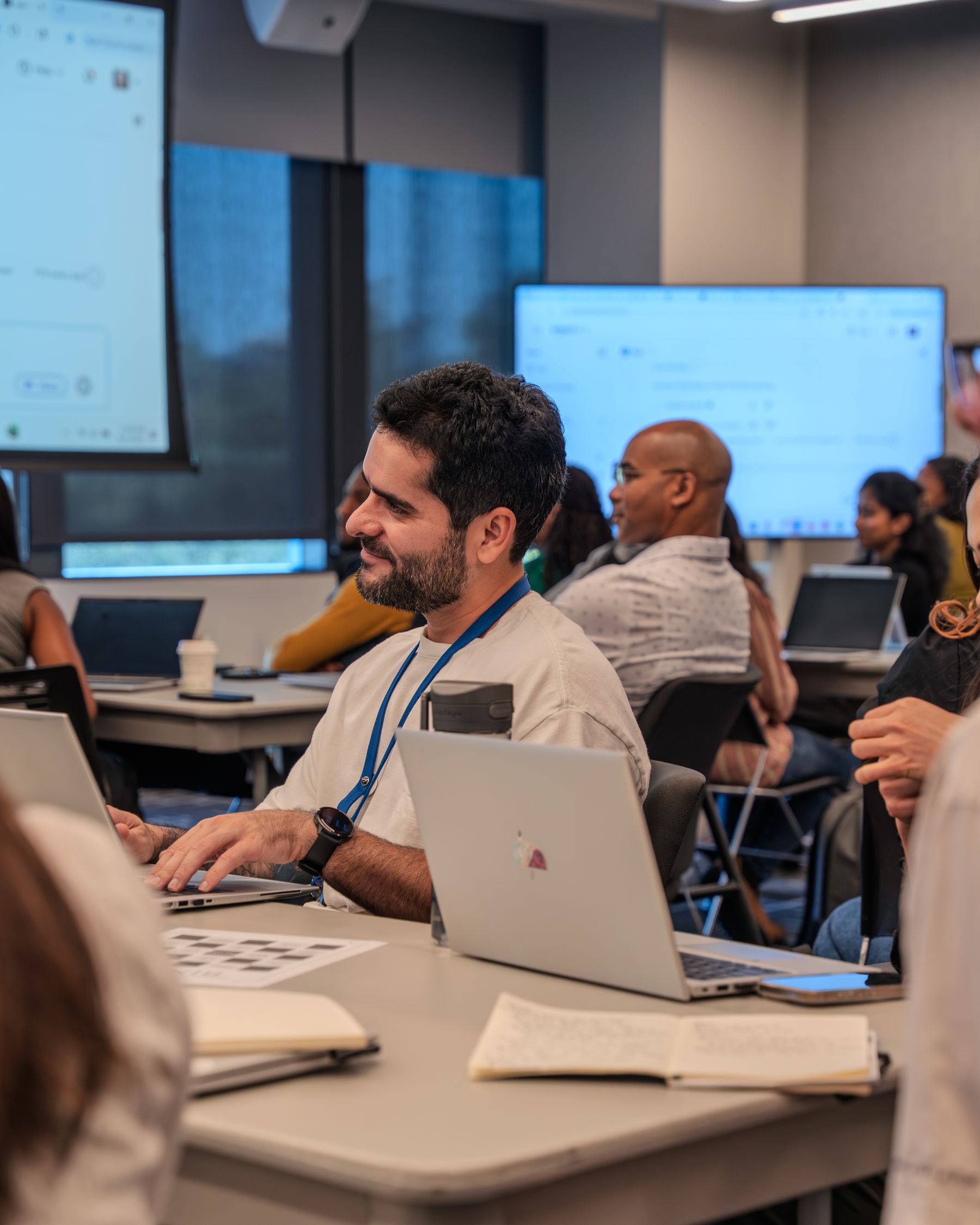 Participants working with laptops in a technology workshop